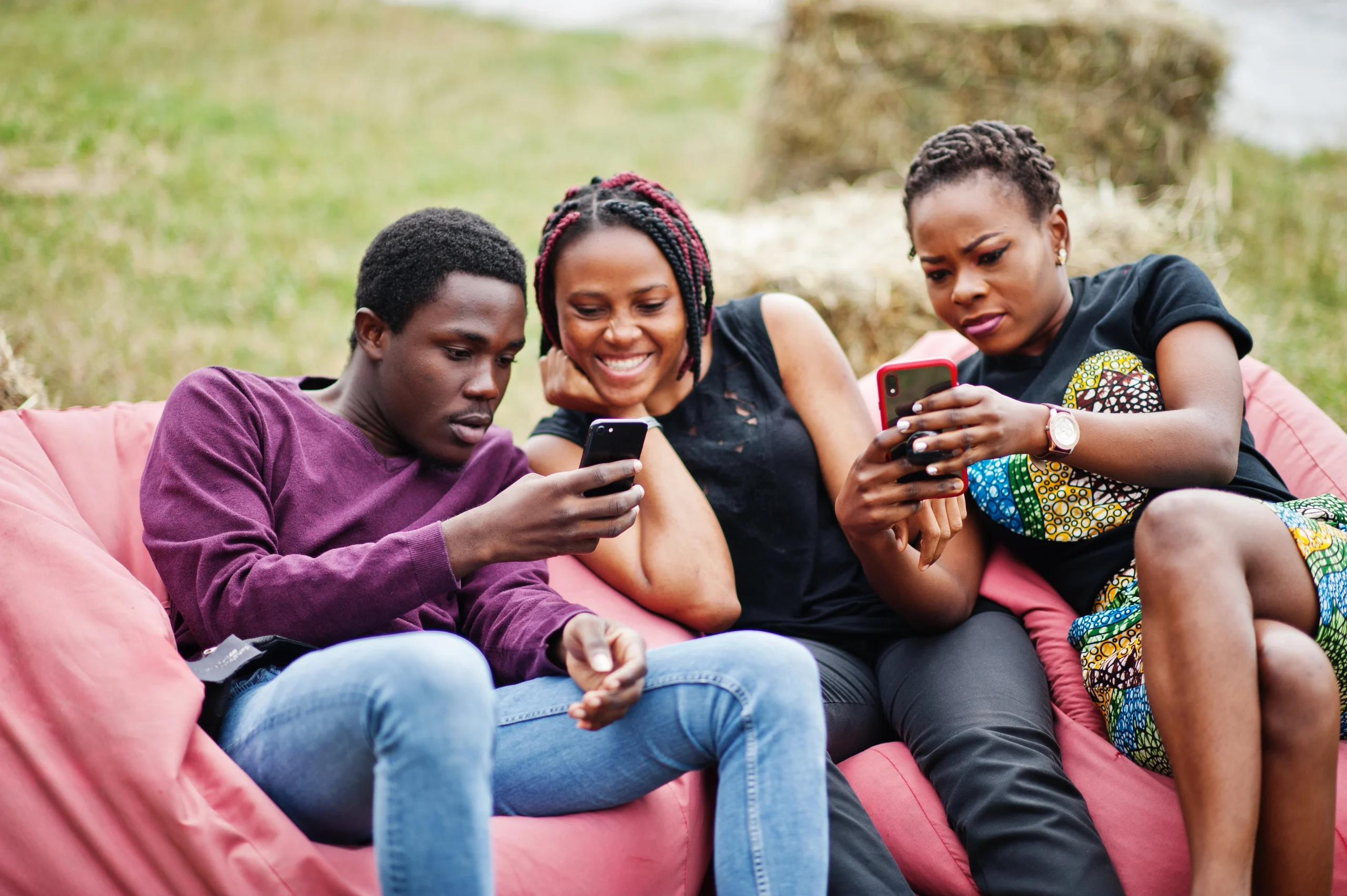 Young Ivorians playing mobile games on smartphones in Abidjan